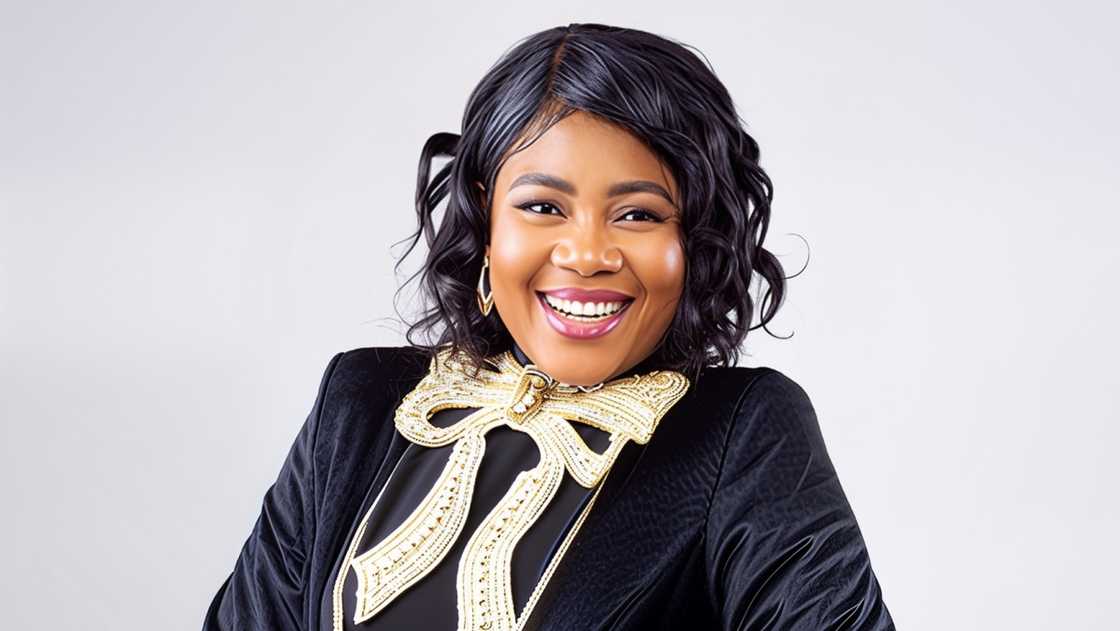 Nigerian businesswoman, actress, and internet personality, Atinuke Ogungbe poses in a green and gold outfit against a grey background Nigerian businesswoman, actress, and internet personality, Atinuke Ogungbe poses in a green and gold outfit against a grey background
