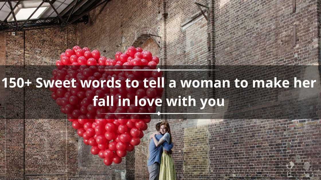 Couple hugging in empty warehouse with red heart made of balloons Couple hugging in empty warehouse with red heart made of balloons